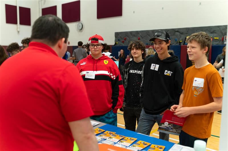 Students talk to various industry representatives at the Manufacturing Day Expo. 